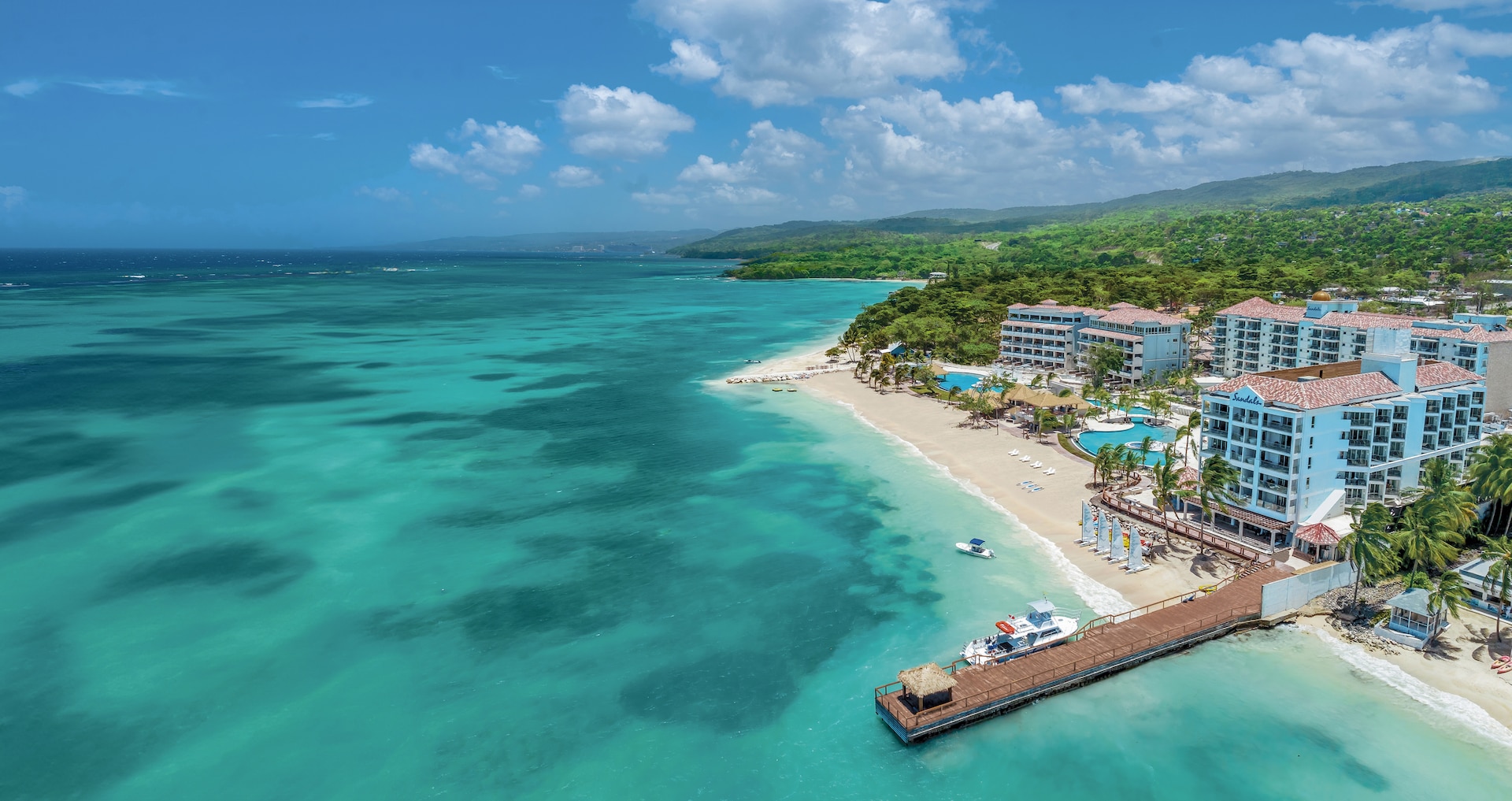 Sandals Dunn's River in Ocho Rios — modern Sandals 2.0 design, rooftop pools, on Mammee Bay