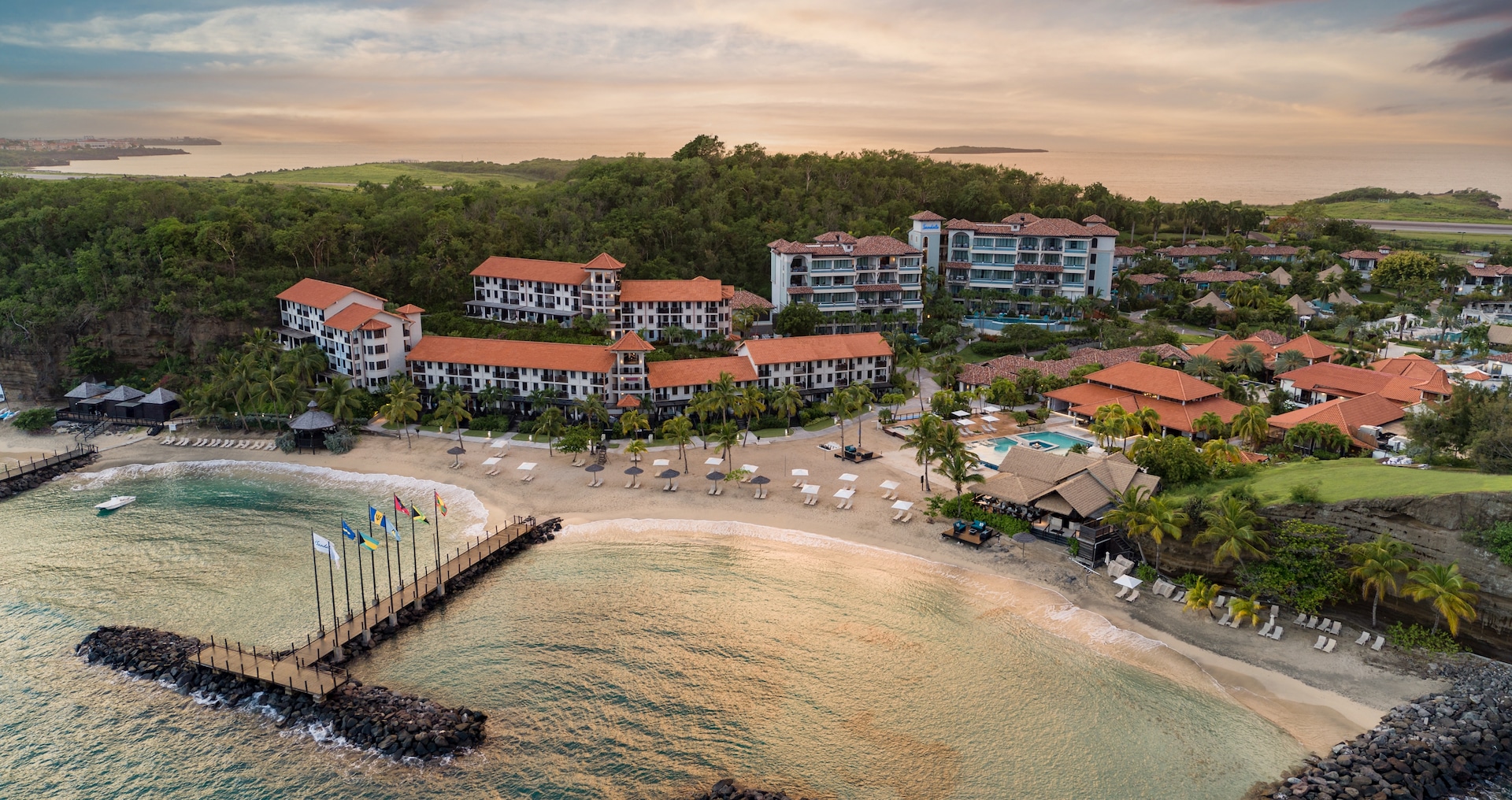Sandals Grenada on Pink Gin Beach — Caribbean Village along the shoreline